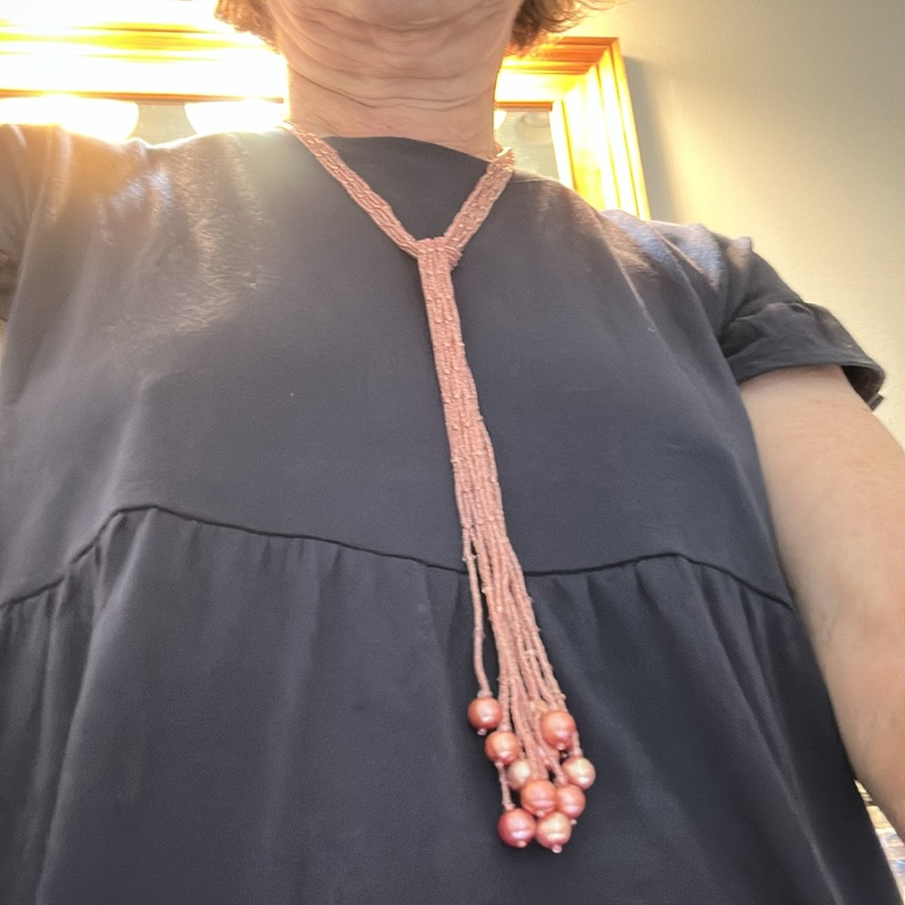 Pink Silk Pouch and 40” strand of pink beads lariat style.